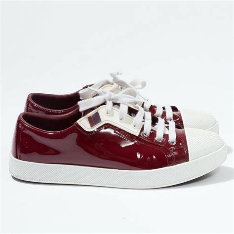 burgundy patent leather prada sneakers.